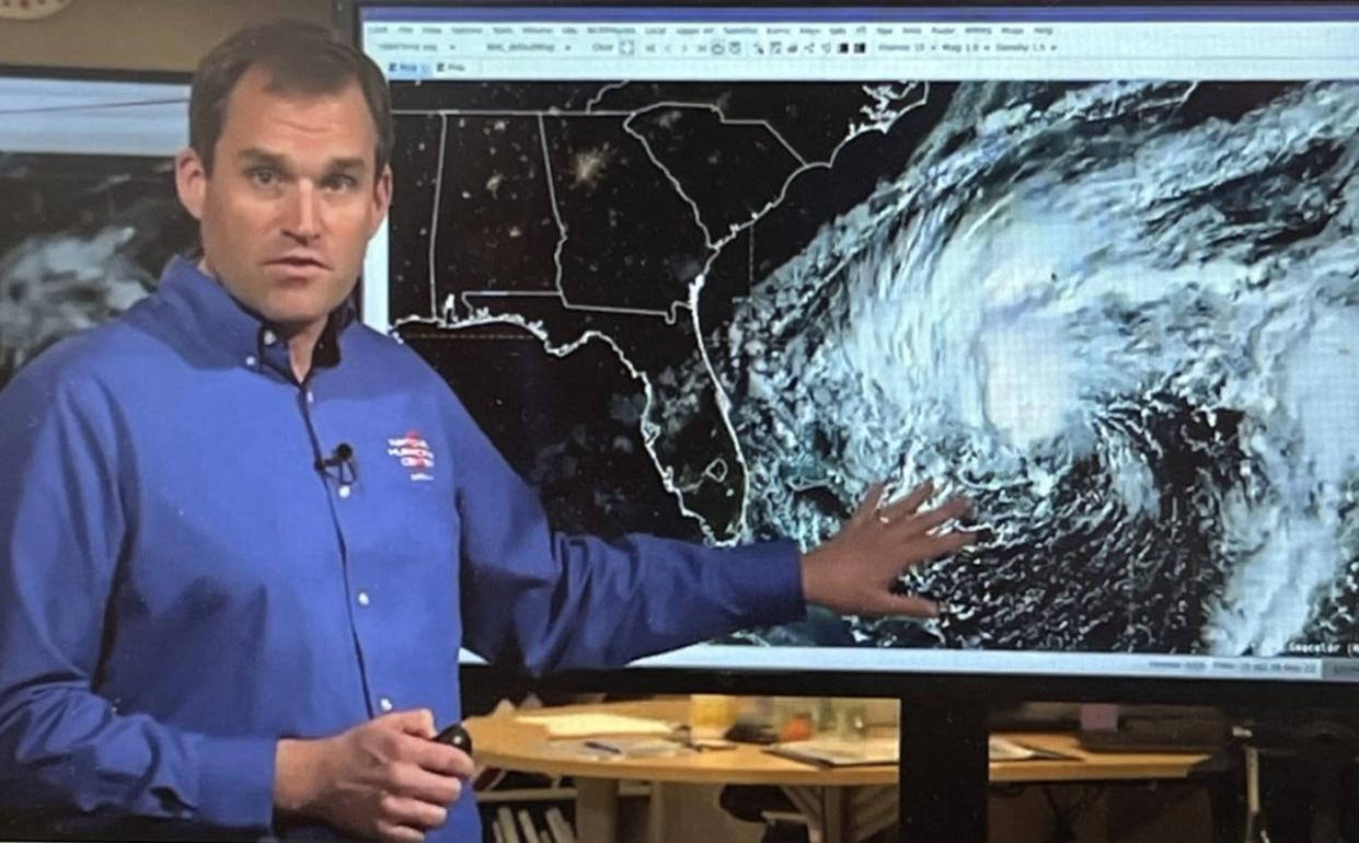 This is a screenshot of Mike Brennan, acting deputy director of the National Hurricane Center, as he gives a live update report on Tropical Storm Nicole on the NHC's website on Tuesday morning, Nov. 8, 2022. Also pictured is a satellite image of Nicole which could intensify into a hurricane by the time it makes landfall in Florida Thursday morning.