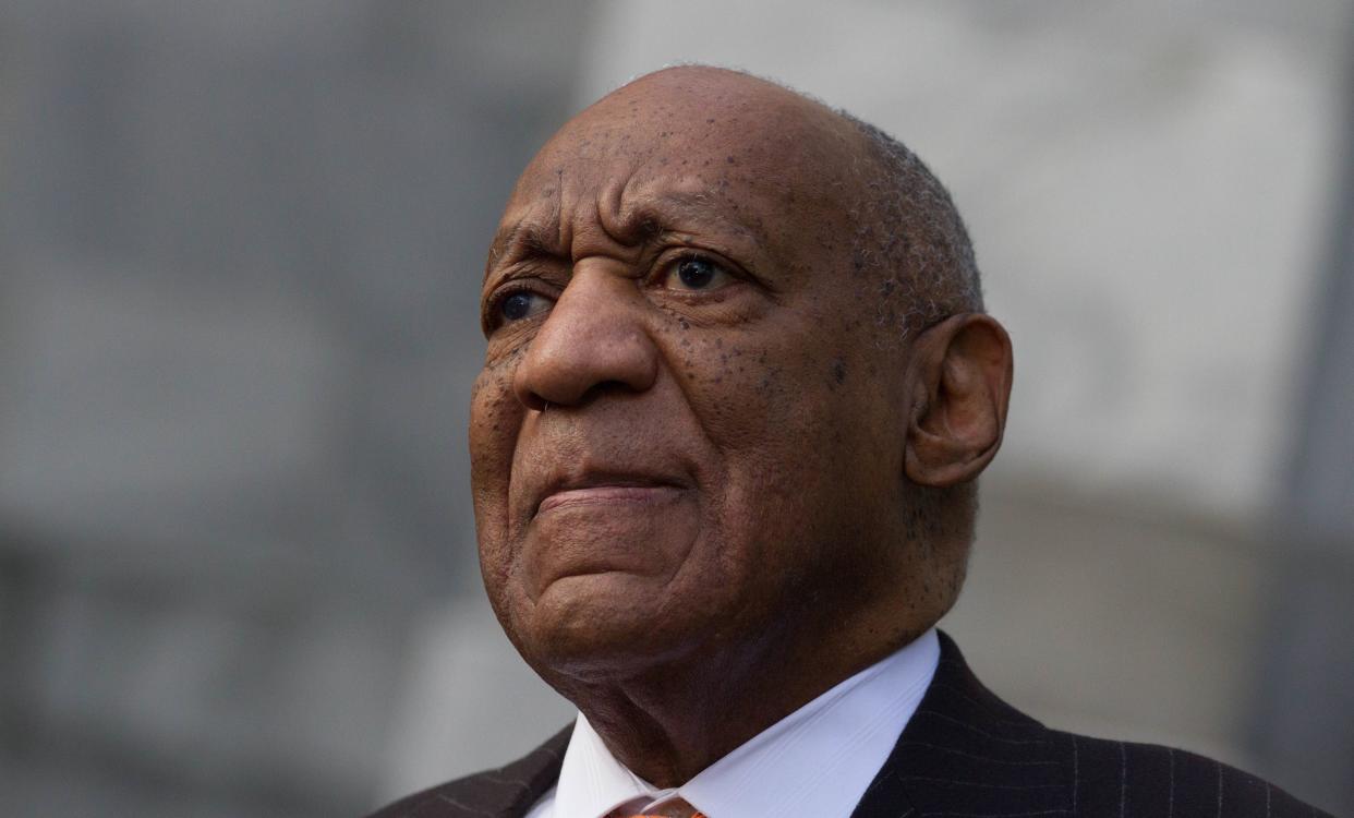 Bill Cosby stands next to his spokesman, Andrew Wyatt, as Wyatt addresses media&nbsp;on Tuesday.&nbsp; (Photo: Pacific Press via Getty Images)