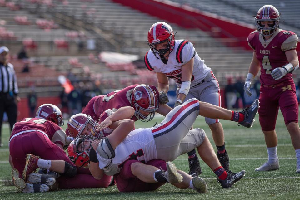 Kingsway Kyle Kupsey gets tackled by Hillsborough's Andrew Santa Barbara. Hillsborough vs. Kingsway football in South Group 5 Regional championship game at Piscataway NJ on December 4, 2021.