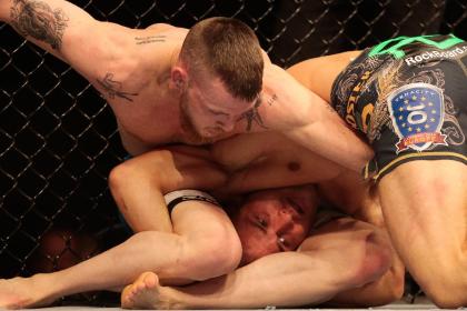 Niklas Backstrom, top, fights Tom Niinimaki from Finland in a featherweight fight, during the UFC Fight Night mixed martial arts event in Berlin. (AP)