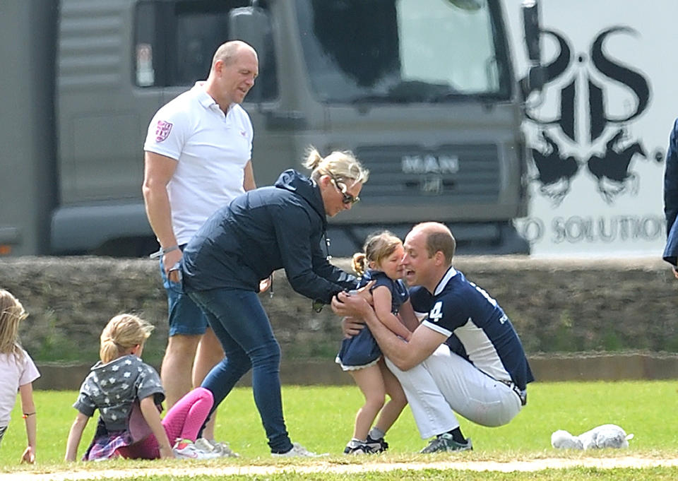 Mike and Zara Tindall watches daughter Mia get a hug from Prince William, Duke of Cambridge at the Maserati Royal Charity Polo Trophy at Beaufort Polo Club on June 11, 2017 in Tetbury, England.  (Photo by Karwai Tang/WireImage)