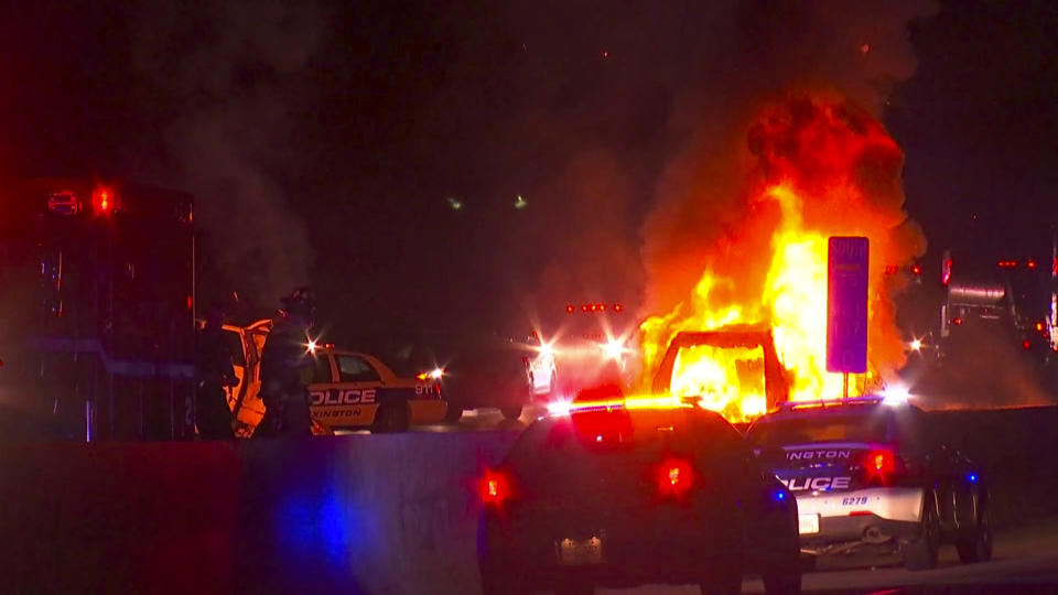 In this photo provided by LEX18, police officers and firefighters work at the scene of a deadly crash on Interstate 75 in Lexington, Ky., Sunday, Jan. 6, 2019. A suspected drunken driver heading the wrong way on a pickup truck struck a vehicle carrying several family members from Michigan early Sunday, killing all occupants of the vehicle, along with the pickup's driver, authorities said. (LEX18 via AP)