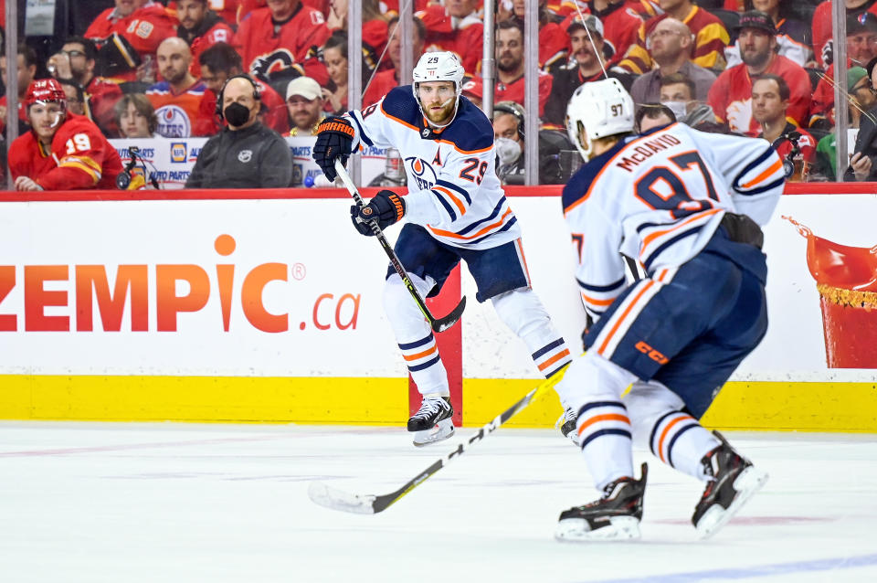 CALGARY, AB - MAY 18: Edmonton Oilers Center Leon Draisaitl (29) passes the puck to Edmonton Oilers Center Connor McDavid (97) during the third period of game 1 of the second round of the NHL Stanley Cup Playoffs between the Calgary Flames and the Edmonton Oilers on May 18, 2022, at the Scotiabank Saddledome in Calgary, AB. (Photo by Brett Holmes/Icon Sportswire via Getty Images)