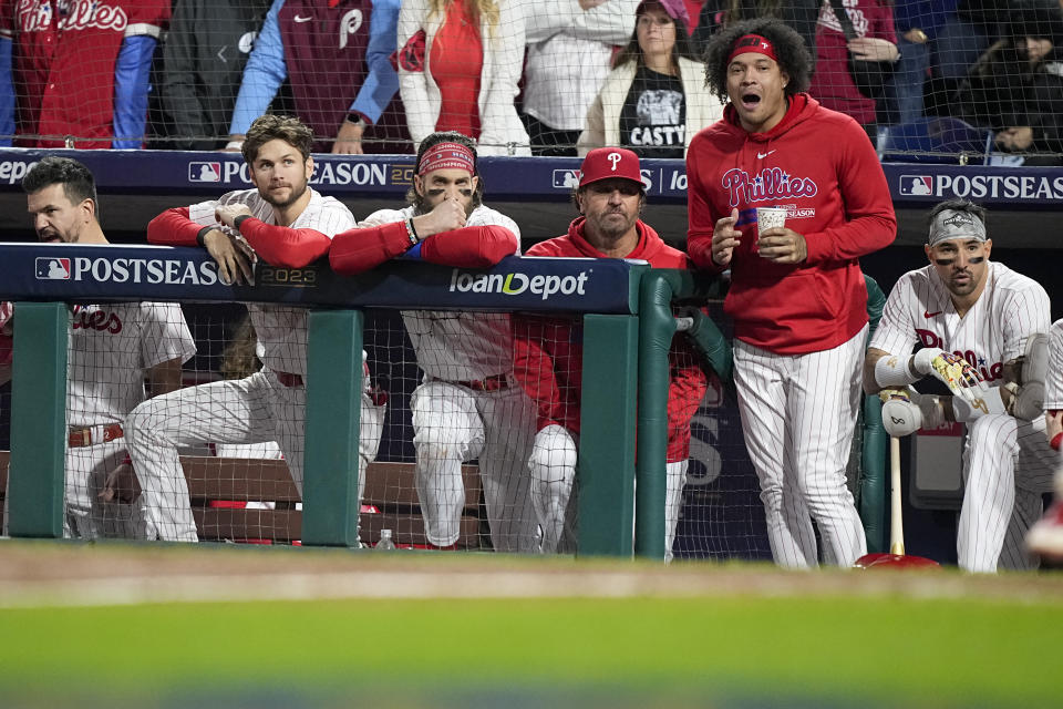 Members of the Philadelphia Phillies watch during the ninth inning in Game 7 of the baseball NL Championship Series against the Arizona Diamondbacks in Philadelphia Tuesday, Oct. 24, 2023. (AP Photo/Brynn Anderson)