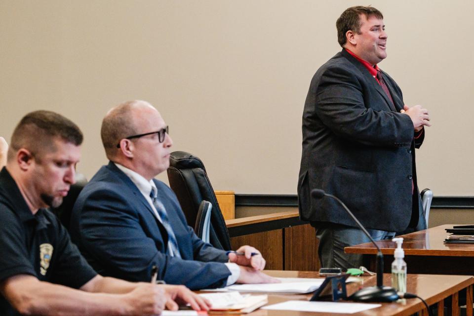 Jeremiah Johnson, right, smiles as he addresses Judge Nanette DeGarmo VonAllman during a hearing on Johnson's failure to remit business taxes, Monday, April 29 in New Philadelphia Municipal Court. Seated at left is Eric Humphrey, a police officer with the Criminal Investigations Division of the Ohio Department of Taxation, and prosecuting attorney Steve Anderson, representing the Village of Sugarcreek.
