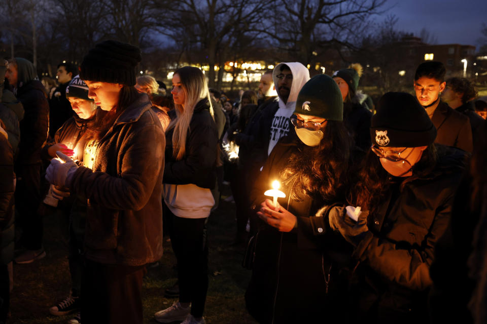 Mourners attend a vigil at The Rock on the grounds of Michigan State University in honor of the students killed and injured in Monday's shootings, in East Lansing, Mich., Wednesday, Feb. 15, 2023. (AP Photo/Al Goldis)