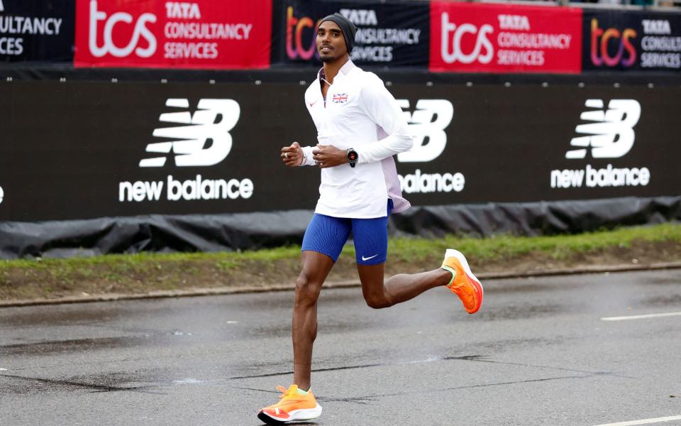 Britain's Mo Farah warming up ahead of the elite men's race - Reuters