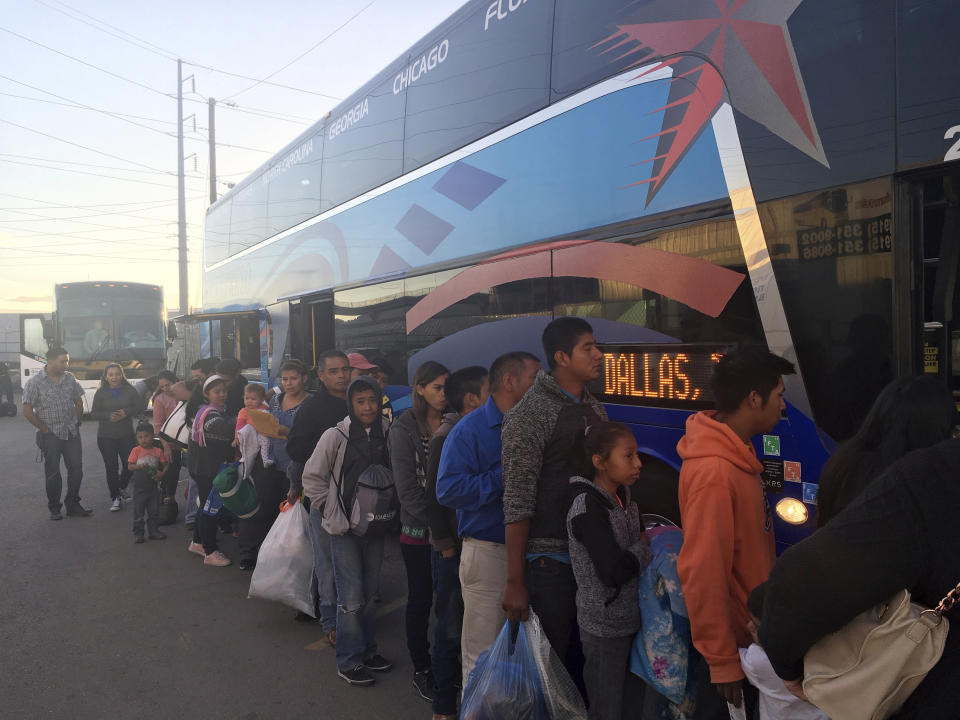 In this April 14, 2019, photo, migrants released by U.S. authorities after crossing the border from Mexico and spending a short time in U.S. custody, board a bus in El Paso, Texas, headed to Dallas. El Paso has swiftly become one of the busiest corridors for illegal border crossings in the U.S. after years as one of the sleepiest. (AP Photo/Elliot Spagat)