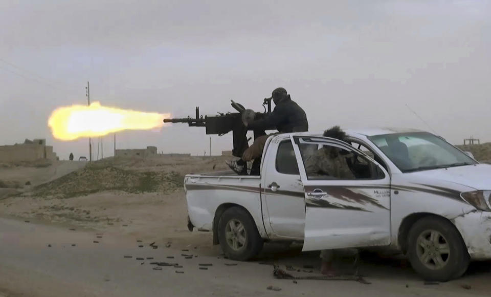 This frame grab from video posted online Friday, Jan. 18, 2019, by supporters of the Islamic State group, purports to show a gun-mounted Islamic State group vehicle firing at members of the U.S.-backed Syrian Democratic Forces, in the eastern Syrian province of Deir el-Zour, Syria. s they cling to the tiny remains of what was once a self-styled caliphate spanning two countries, IS militants are laying the groundwork for an insurgency. Activists say they are carrying out targeted assassinations, setting up flying checkpoints and distributing fliers to intimidate residents. They fear the group could stage an even bigger comeback if U.S. forces withdraw from Syria. (Militant Photo via AP)