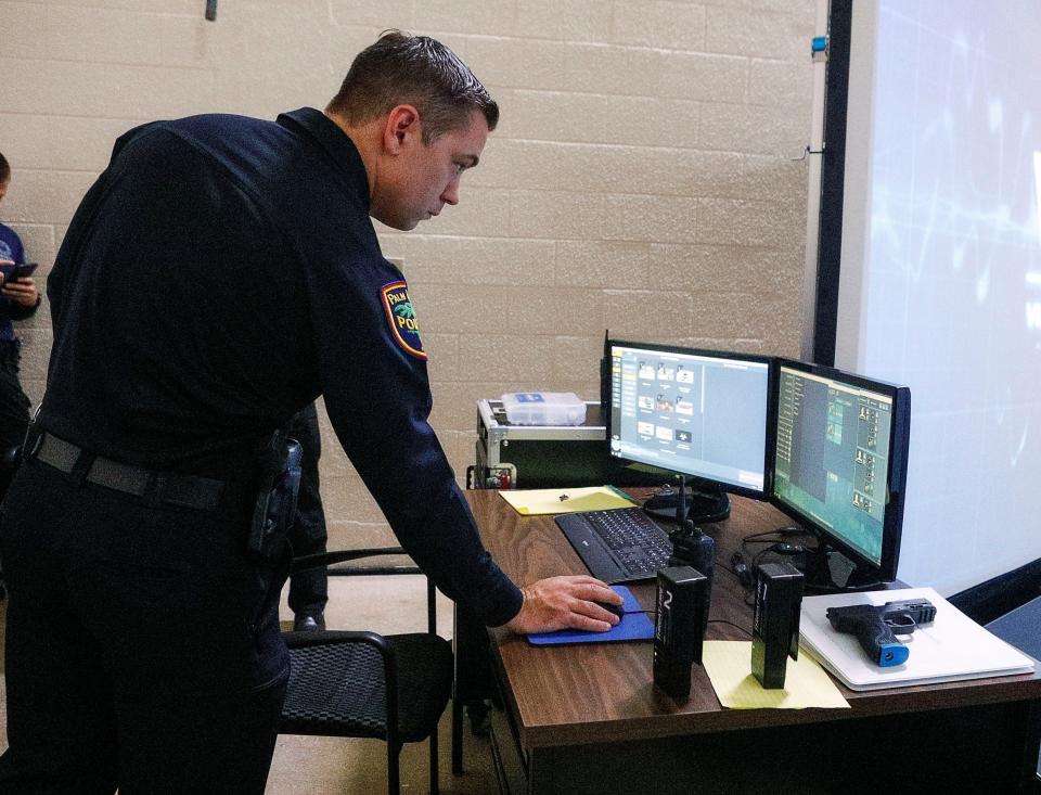 Capt. Will Rothrock operates the department's brand new VirTra 300-degree law enforcement small arms simulator in June 2020.