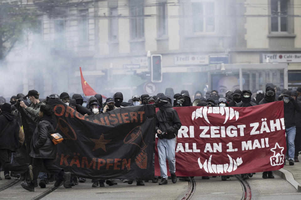 People take part in a 'Feminist Revolution' May Day protest rally and some clash with the police in Zurich, Switzerland, Monday, May 1, 2023. (Ennio Leanza/Keystone via AP)