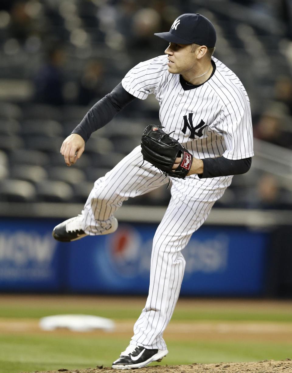 New York Yankees relief pitcher David Phelps follows through on a ninth-inning pitch in the Yankees' 4-1 victory over the Boston Red Sox in a baseball game at Yankee Stadium in New York, Thursday, April 10, 2014. (AP Photo/Kathy Willens)