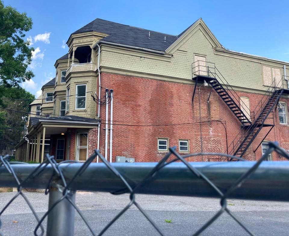 A stretch of apartment buildings on the 800 block of N. Adams Street remains vacant and behind fencing as significant repairs appear to still be needed before the buildings are considered habitable, seen Wednesday, July 5, 2023.
