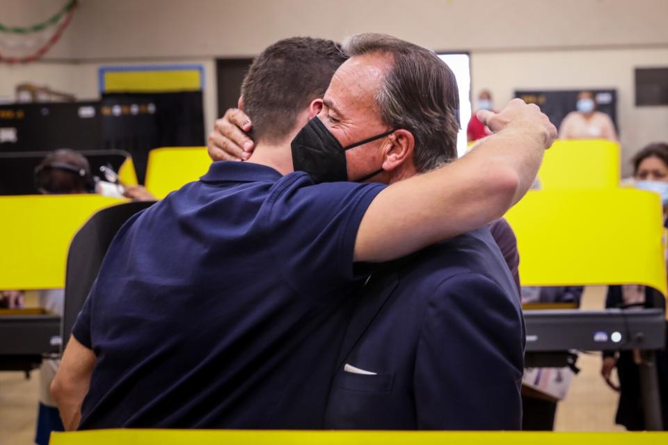 Mayoral candidate Rick Caruso hugs his son