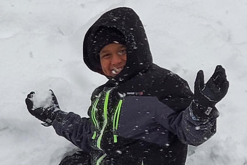 Ahmir Jolliff, who was killed in a school shooting on Thursday, Jan. 4, 2024, in Perry, Iowa, plays in the snow in this undated photo. He was 11 years old and a sixth grader when he died in the shooting at Perry High School.