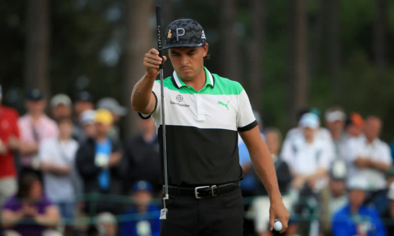 Rickie Fowler holding his putter.