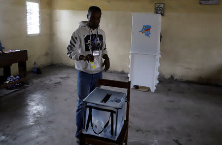 A voter casts his ballot at a polling station during the presidential election in Kinshasa, Democratic Republic of Congo, December 30, 2018. REUTERS/Kenny Katombe
