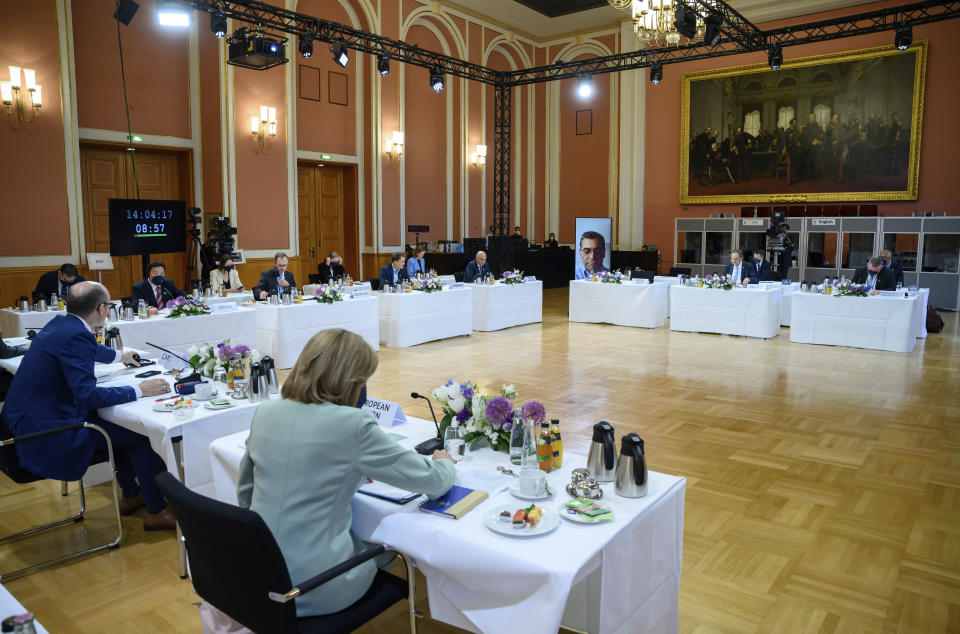 German Health Minister Karl Lauterbach, rear center, speaks as he opens a working session of a health ministers of the G7 countries in the Red City Hall in Berlin, Germany, Thursday, May 19, 2022. On the screen is Xavier Becerra, Health Minister of the USA, who cannot attend in person due to a corona infection. Photo: (Bernd von Jutrczenka/dpa via AP)