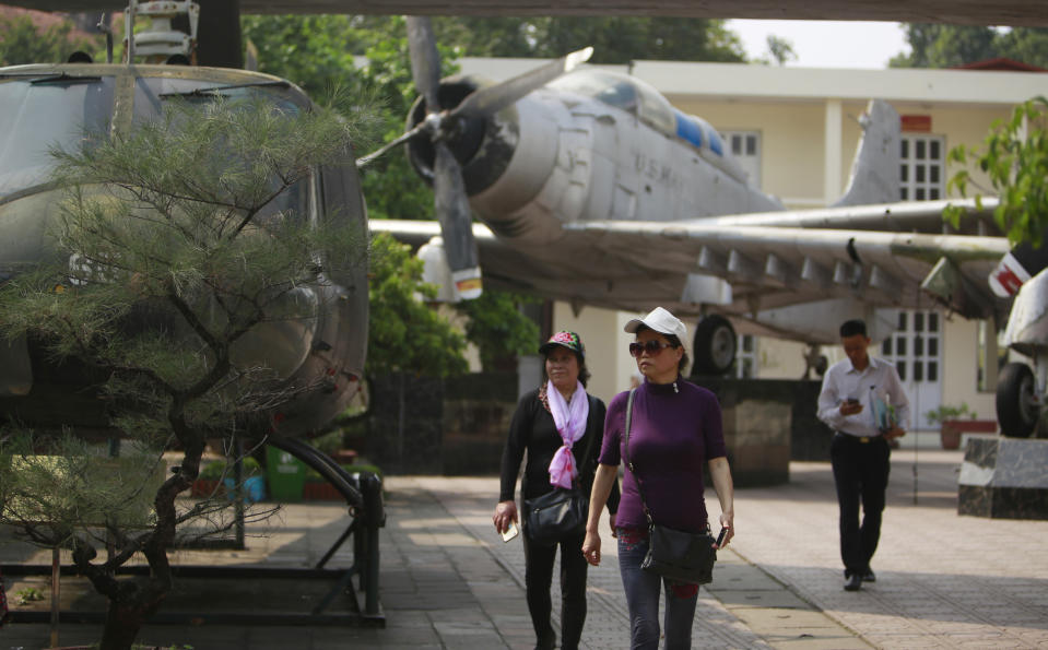 In this Feb. 21, 2019, photo, visitors walk next to American aircraft at the Vietnam Military History Museum in Hanoi, Vietnam. The Vietnamese capital once trembled as waves of American bombers unleashed their payloads, but when Kim Jong Un arrives here for his summit with President Donald Trump he won’t find rancor toward a former enemy. Instead, the North Korean leader will get a glimpse at the potential rewards of reconciliation. (AP Photo/Hau Dinh)