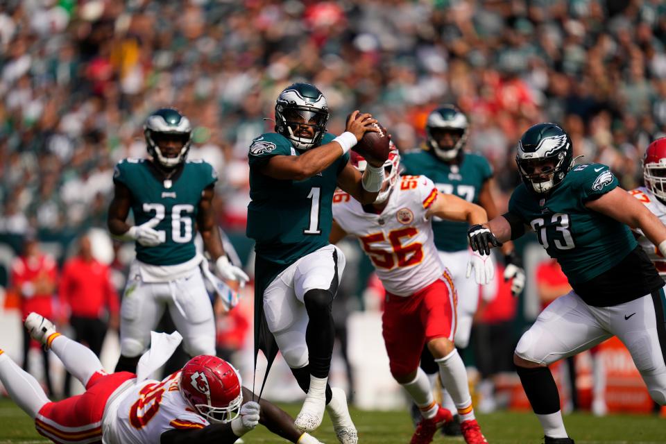 Philadelphia Eagles quarterback Jalen Hurts (1) looks to pass in front of Kansas City Chiefs defensive tackle Jarran Reed (90) during the first half of an NFL football game Sunday, Oct. 3, 2021, in Philadelphia.