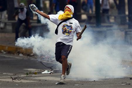 An anti-government protester throws a teargas canister back at the police during a protest at Altamira square in Caracas March 10, 2014. REUTERS/Jorge Silva