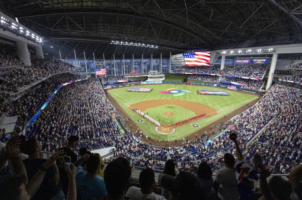 Fans stand for the national anthem before a World Baseball Classic game between the United States and Cuba, Sunday, March 19, 2023, in Miami. (Matias J. Ocner/Miami Herald via AP)