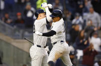 New York Yankees' Juan Soto celebrates with Aaron Judge after hitting a home run against the Miami Marlins during the fourth inning of a baseball game, Monday, April 8, 2024 in New York. (AP Photo/Noah K. Murray)