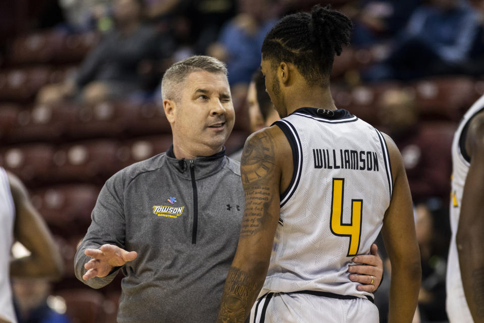 Towson's head coach Pat Skerry, left, talks with player Dylan Williamson (4) in the first half of an NCAA college basketball game against Houston during the Charleston Classic in Charleston, S.C., Thursday, Nov. 16, 2023. (AP Photo/Mic Smith)