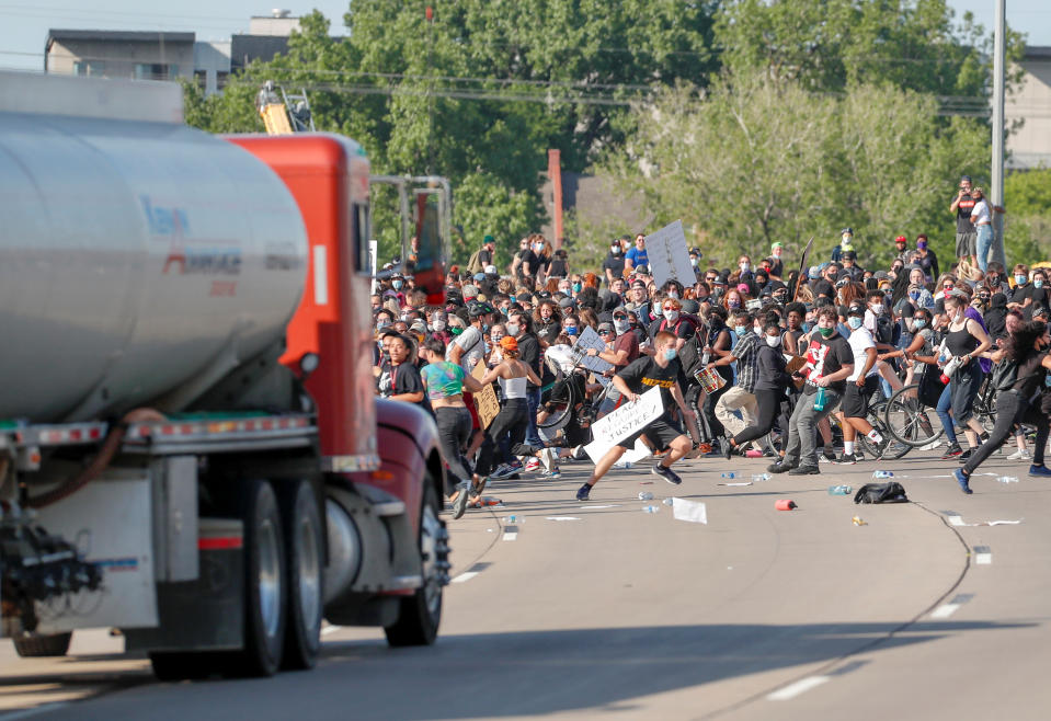 Crowds run as the tanker truck drives into thousands of protesters.