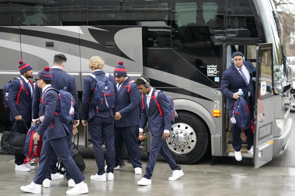 Arizona football players arrive at Rice-Eccles Stadium before their NCAA college football game against Utah Saturday, Nov. 5, 2022, in Salt Lake City. College athletic programs of all sizes are reacting to inflation the same way as everyone else. In the Power Five, home of college sports' biggest budgets and most considerable resources, schools are working with boosters and other partners to try to bridge the financial gap. (AP Photo/Rick Bowmer)