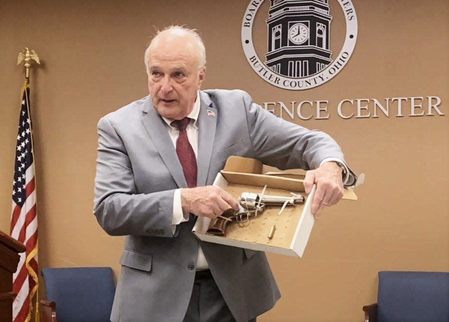 Butler County Prosecutor Michael Gmoser shows the revolver he said Dustin Booth pointed at Monroe police officers before Booth was fatally shot by those officers in February.