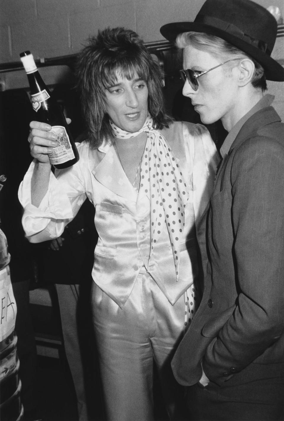 <p>Rod Stewart chats with David Bowie backstage after a performance at Madison Square Garden in 1975. </p>