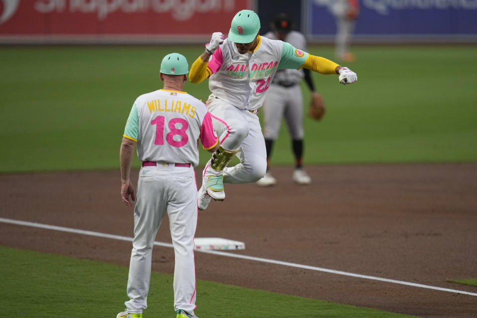 San Diego Padres' Juan Soto, right, celebrates with third base coach Matt Williams after hitting a home run during the first inning of a baseball gameagainst the San Francisco Giants, Friday, Sept. 1, 2023, in San Diego. (AP Photo/Gregory Bull)