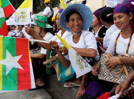 People wait outside the residence of Cardinal Charles Maung Bo, Archbishop of Yangon, where Pope Francis will be staying during his visit in Yangon, Myanmar November 27, 2017. REUTERS/Jorge Silva