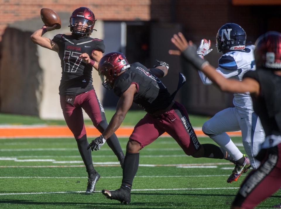 Peoria High quarterback Tino Gist throws under pressure from Nazareth Academy in the second half of the Class 5A football state title game Saturday, Nov. 26, 2022 in Champaign.