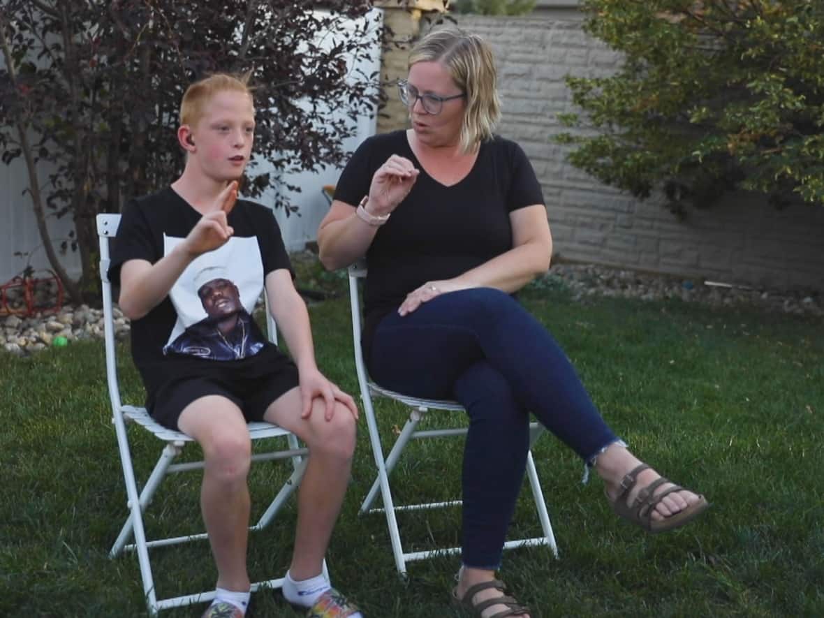 Michelle and Oscar Grodecki began learning American Sign Language against the advice of their speech pathologist when the boy was 18 months old. About a decade later, both mother and son are fluent in ASL and use it every day to communicate. (Matt Howard/CBC - image credit)