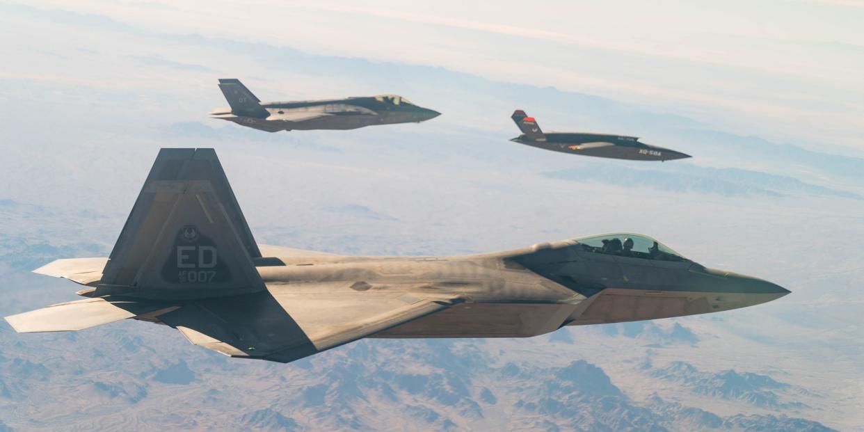 A U.S. Air Force F-22 Raptor and F-35A Lightning II fly in formation with the XQ-58A Valkyrie low-cost unmanned aerial vehicle over the U.S. Army Yuma Proving Ground testing range, Ariz., during a series of tests Dec. 9, 2020