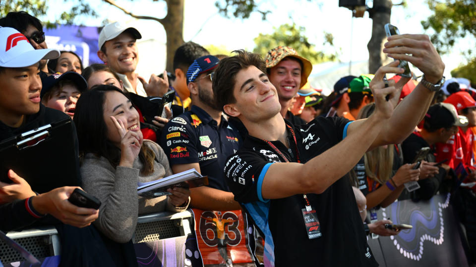 Formula 1's Jack Doohan, the reserve driver for Alpine, takes a moment for selfies with fans before the 2024 Australian Grand Prix.