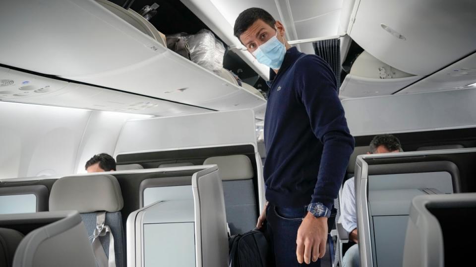 Novak Djokovic prepares to take his seat on a plane to Belgrade, in Dubai, United Arab Emirates, on January 17, 2022. (Darko Bandic/AP)