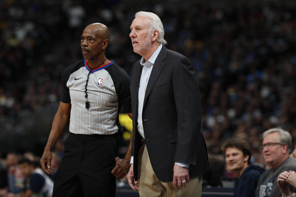 FILE - This April 13, 2019 file photo shows San Antonio Spurs head coach Gregg Popovich and referee Tom Washington (49) in the second half of Game 1 of an NBA first-round basketball playoff series in Denver. The only instances of NBA referees Washington, Tony Brown and Courtney Kirkland all officiating together are some offseason pro-am games in Atlanta, the city they all call home. That will change Sunday, March 7, 2021. The trio was chosen as the officiating crew for this year’s All-Star Game. (AP Photo/David Zalubowski, File)