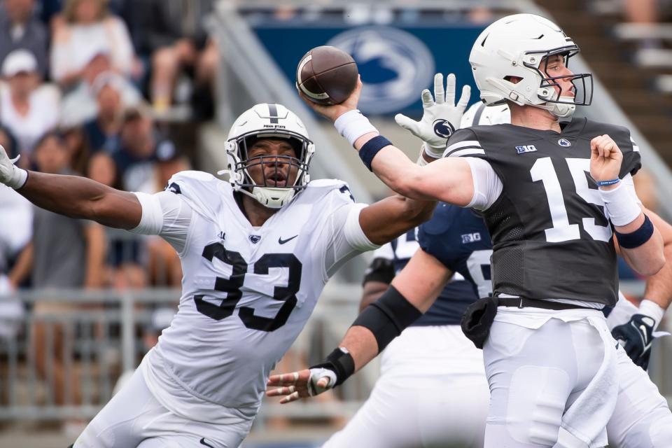 Penn State quarterback Drew Allar gets a pass off before defensive end Dani Dennis-Sutton (33) can get a hit in during the Blue-White game at Beaver Stadium on Saturday, April 15, 2023, in State College. Dennis-Sutton led all players with two sacks in the game.