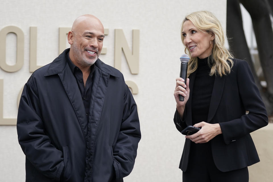 Jo Koy, left, listens as Helen Hoehne speaks during the Golden Globe Awards Press Preview at the Beverly Hilton, Thursday, Jan. 4, 2024, in Beverly Hills, Calif. (AP Photo/Ashley Landis)