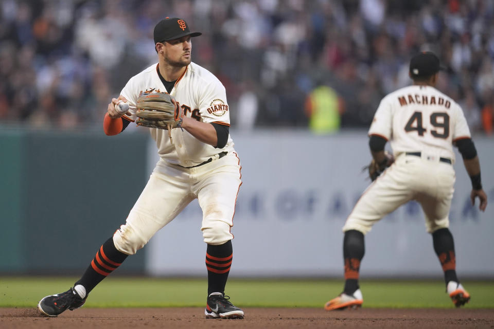 San Francisco Giants third baseman J.D. Davis prepares to throw out Los Angeles Dodgers' Mookie Betts at first base during the fifth inning of a baseball game in San Francisco, Wednesday, Aug. 3, 2022. (AP Photo/Jeff Chiu)