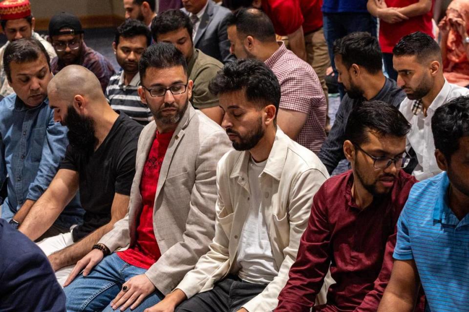 People engage in prayer during the annual interfaith Iftar dinner in observance of Ramadan hosted by the Center for Muslim World Studies at Florida International University Graham Center Ballroom in Miami, Florida, on Tuesday, March 19, 2024.