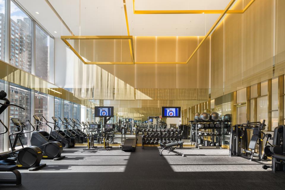 an indoor gym with machines on the 16th floor in luxury skyscraper Central Park Tower