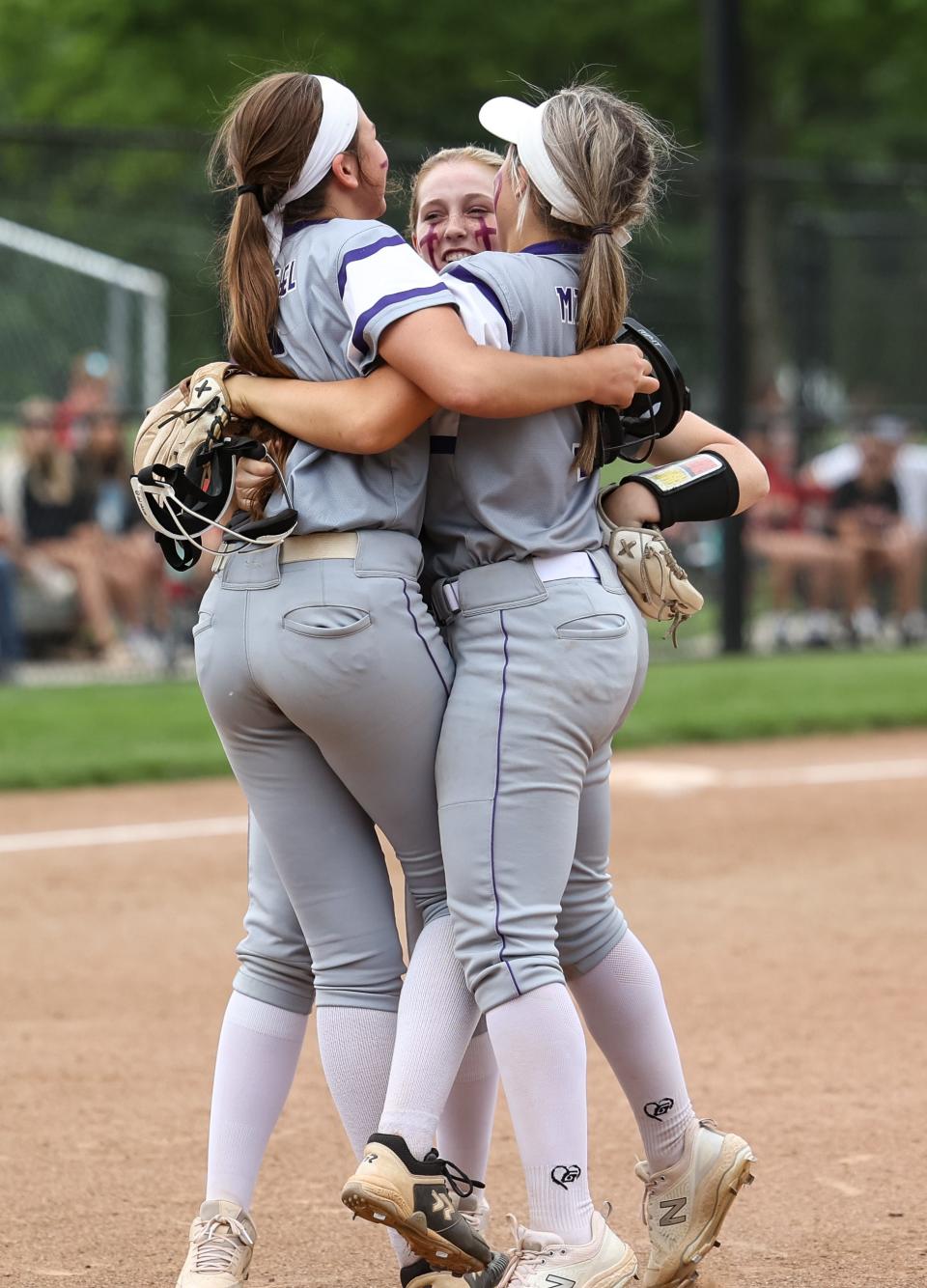 Triway's Carter Wachtel (left), Haylee Pruitt (center) and Hailey Massaro (right) leap in celebration after defeating Canfield to advance to the regional finals.