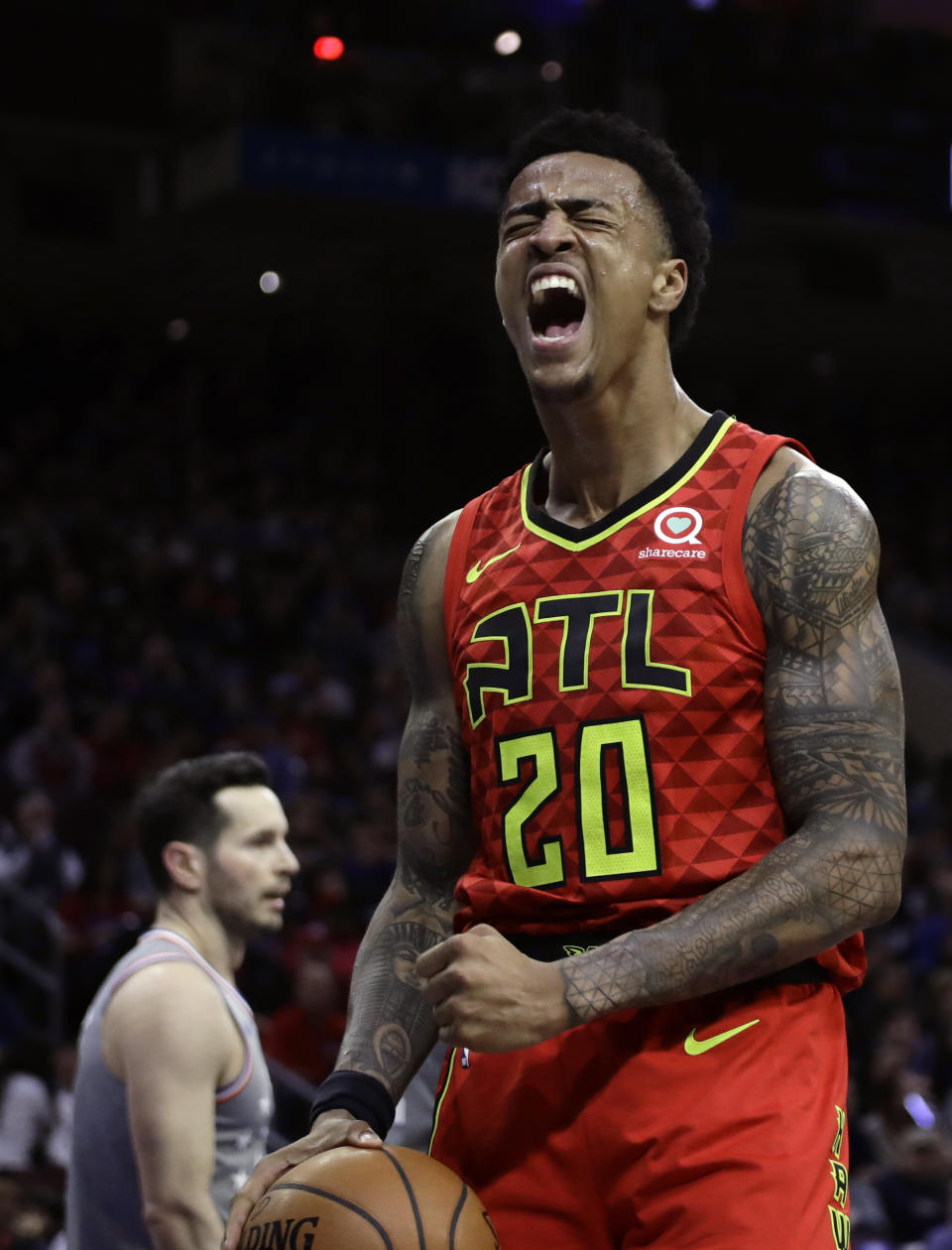 Atlanta Hawks' John Collins reacts after scoring during the first half of an NBA basketball game against the Philadelphia 76ers, Friday, Jan. 11, 2019, in Philadelphia. (AP Photo/Matt Slocum)