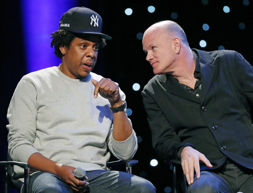 Entrepreneur and business mogul Shawn "Jay-Z" Carter left, speaks to Michael Novogratz, founder and CEO of Galaxy Digital, during the launch of REFORM Alliance, a partnership among entertainment moguls, recording artists, business and sports leaders who hope to transform the American criminal justice system, Wednesday, Jan. 23, 2019, in New York. The group is led by Van Jones, a CNN host, activist and former adviser to President Barack Obama. (AP Photo/Kathy Willens)