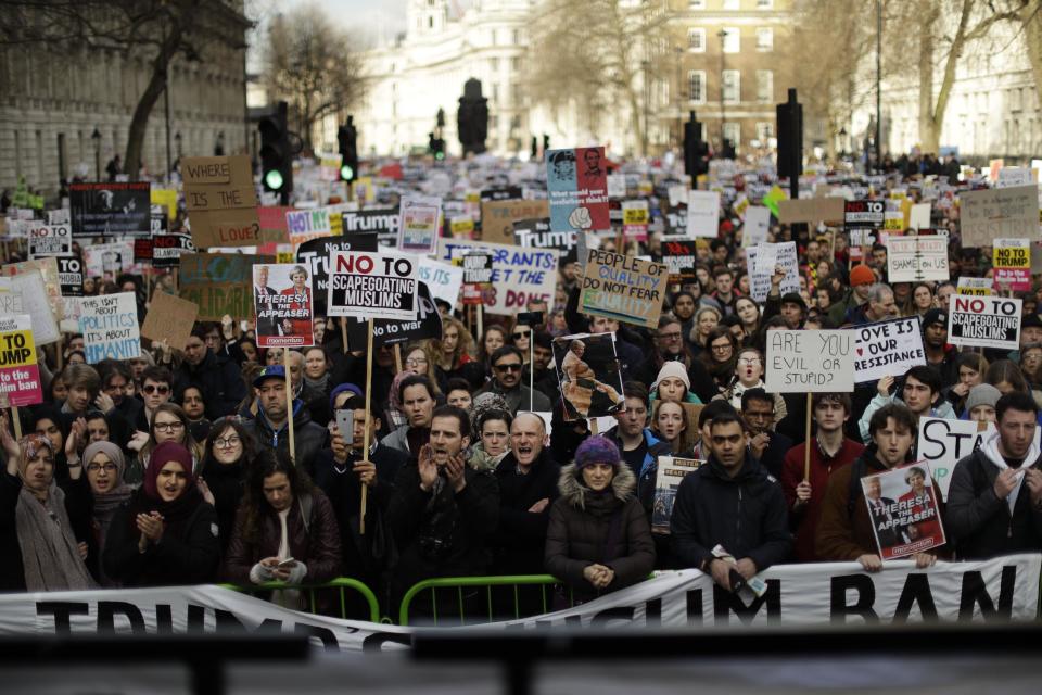 People listen to speakers during a rally at the end of a protest march on Whitehall in London, against U.S. President Donald Trump's ban on travellers and immigrants from seven predominantly Muslim countries entering the U.S., Saturday, Feb. 4, 2017. (AP Photo/Matt Dunham)