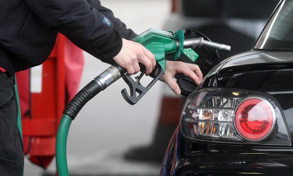 a motorist fills his tank